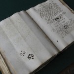 Inky cat pawprints on 15th century manuscript