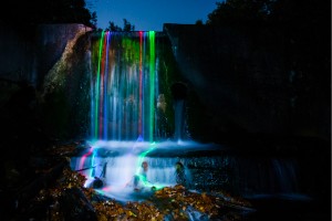 Glowsticks leaving colorful trails in waterfall (3)