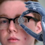 Patrick Kane holding a coin with his iLimb hand