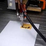 3D printer printing chocolate onto crackers