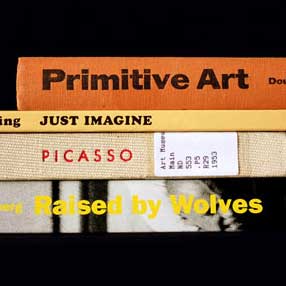 Book spines: "Primitive Art" "Just Imagine" "Picasso" "Raised by Wolves"