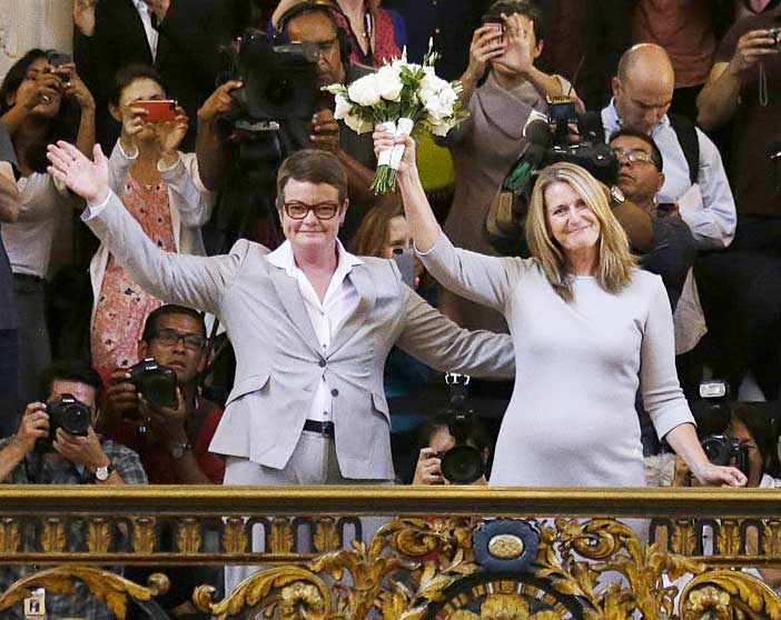 Kris Perry and Sandy Stier wave to the crowd