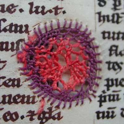 Hole in manuscrip repaired with embroidery