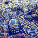 Cosplayers dressed in fabric that matches carpet