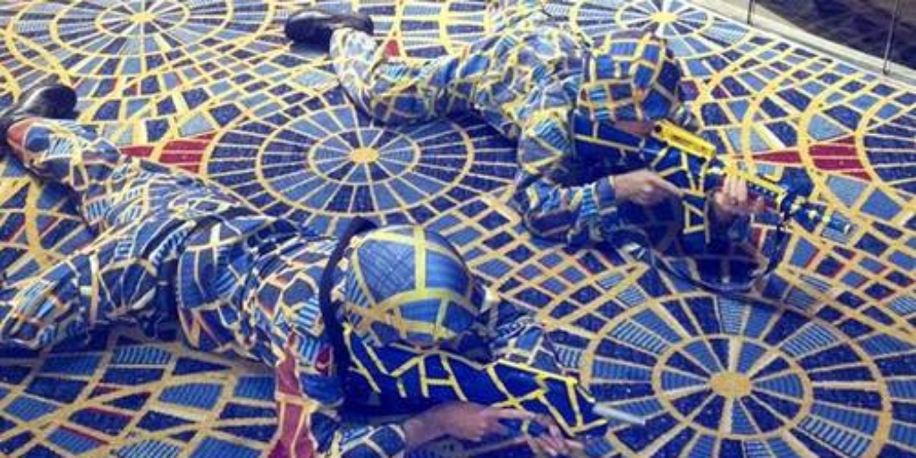 Cosplayers dressed in fabric that matches carpet