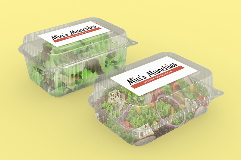 Photograph of two clear food containers filled with green salad; red and black logos on white labels; yellow background.