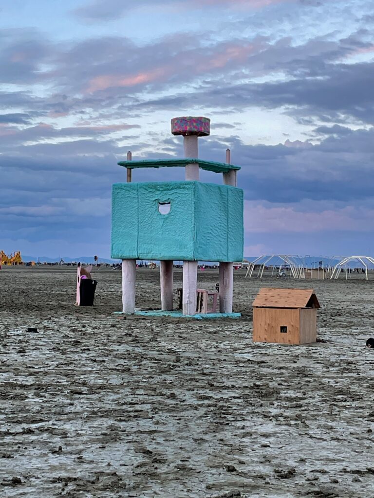 From a distance: a human-scale cat tree carpeted in teal fake fur with sisal-wound supports. Supposedly there were three large cat tree art pieces this year but I only saw this one. We didn't go in as it was closed due to the recent rain.