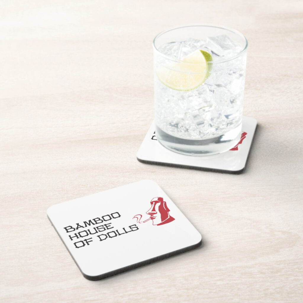 Square coasters with Bamboo house of Dolls logo, on marbled counter. A cocktail glass with clear liquid sits on one of the coasters.