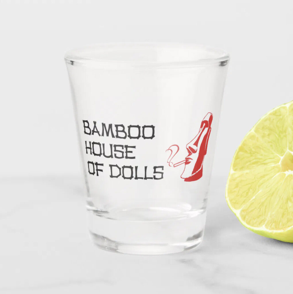 Clear shot glass with Bamboo House of Dolls logo on it