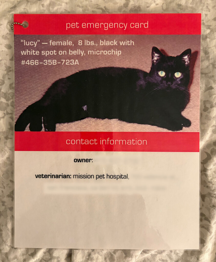 Photo of Lucy's "pet emergency card," which I attached to her carrier. The top part has a photo of her lying down and her name, sex, color, weight and microchip number. The bottom part has contact information and the name and address of her vet (both blocked out).