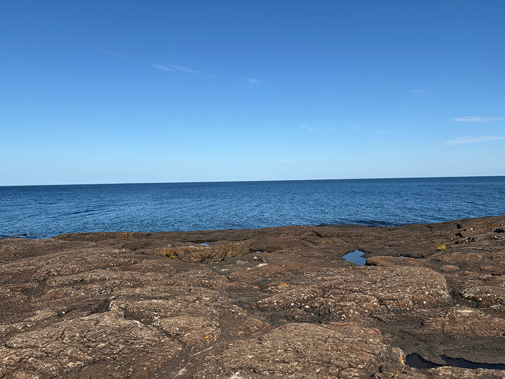 Dark rocks against blue sky