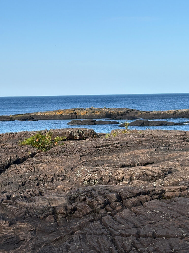 Dark rocks against blue sky