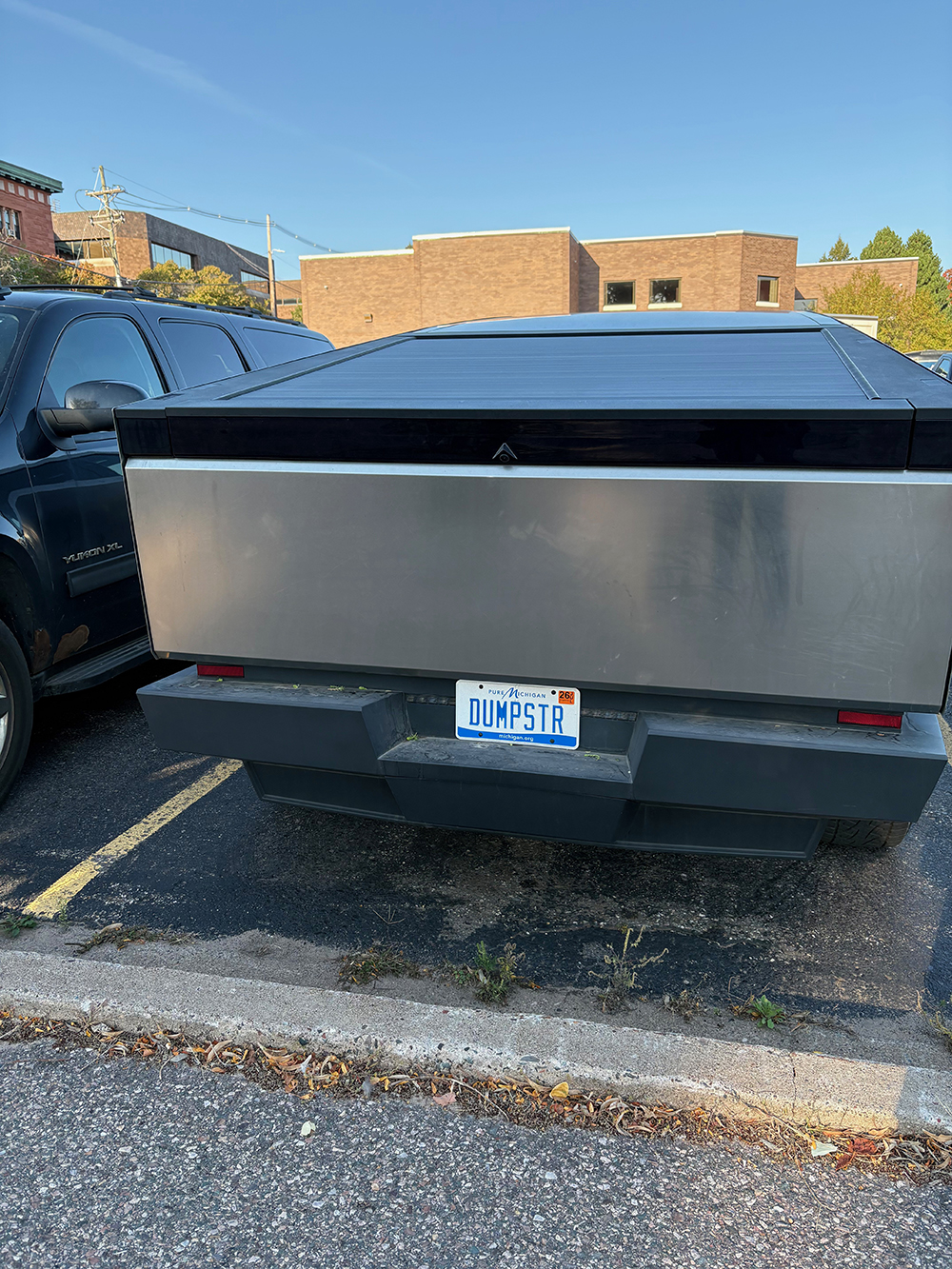 Back of Tesla Cybertruck with "DUMPSTER" license plate