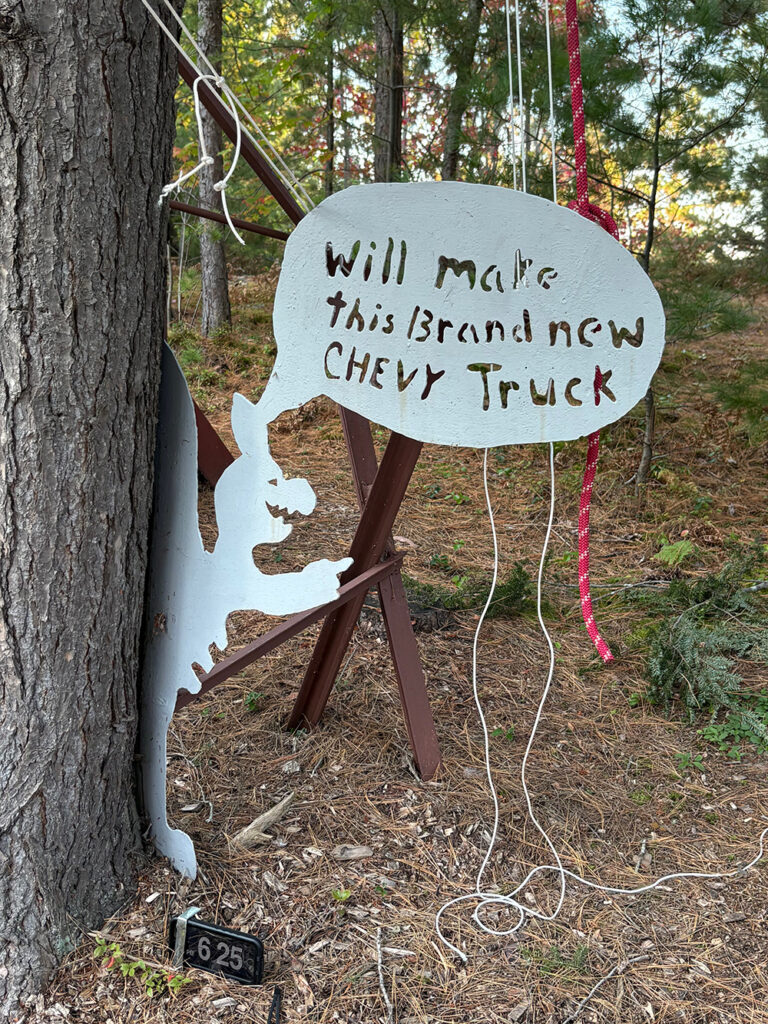 Sign with little creature saying "Will make this brand new Chevy truck"