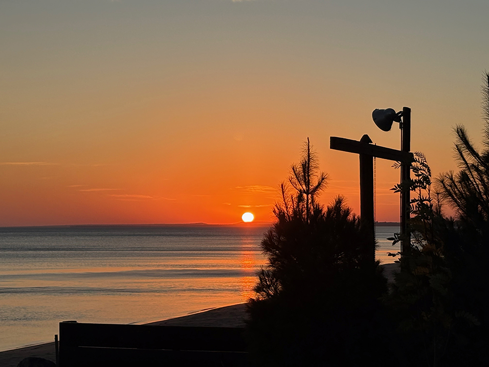 Colorful sunrise over lake - sun is above horizon