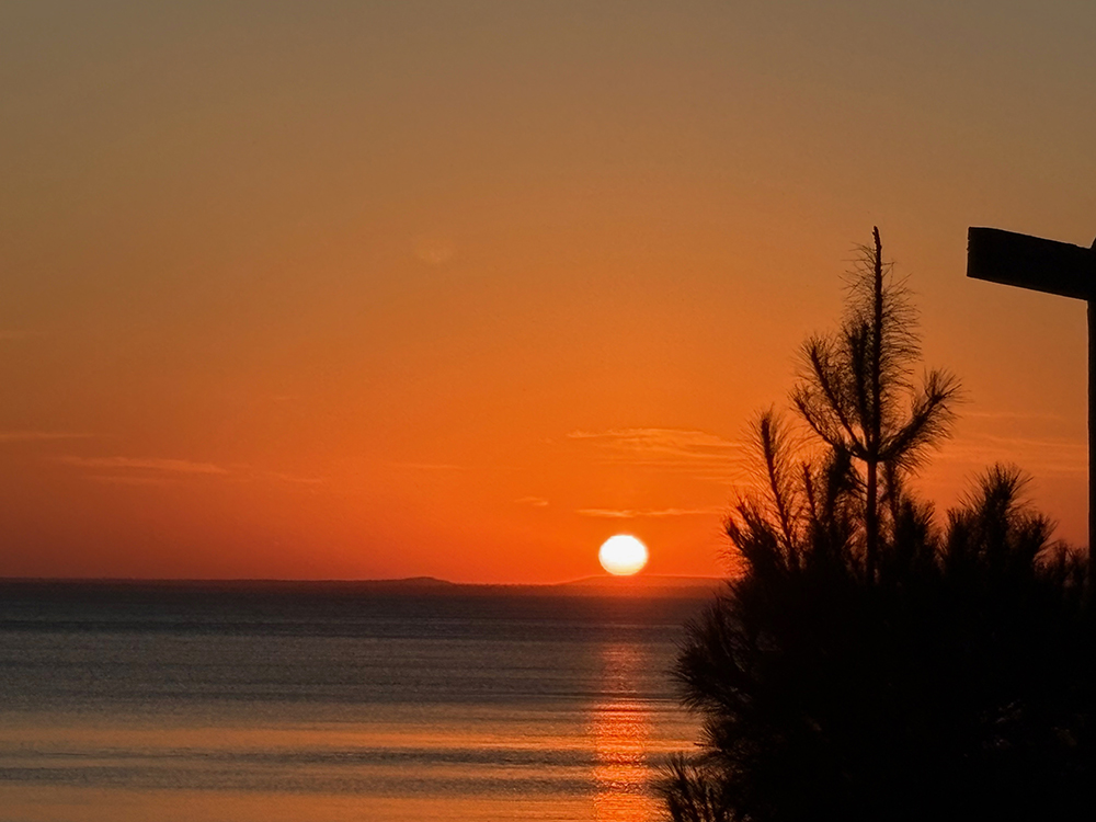 Colorful sunrise over lake - sun is above horizon